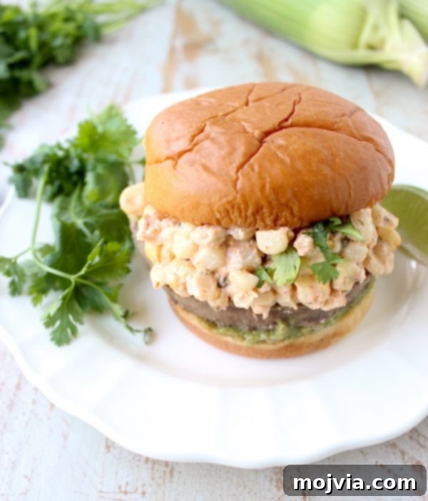 Zesty Elote Turkey Burgers 6 Mexican turkey burgers are covered in cotija cheese, guacamole and grilled Mexican street corn for a flavorful summer burger recipe!