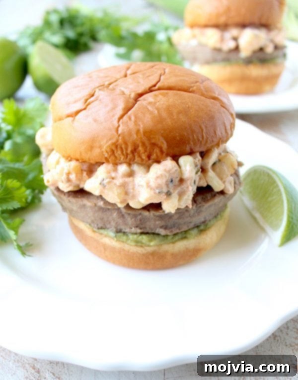 Zesty Elote Turkey Burgers 7 Mexican turkey burgers are covered in cotija cheese, guacamole and grilled Mexican street corn for a flavorful summer burger recipe!
