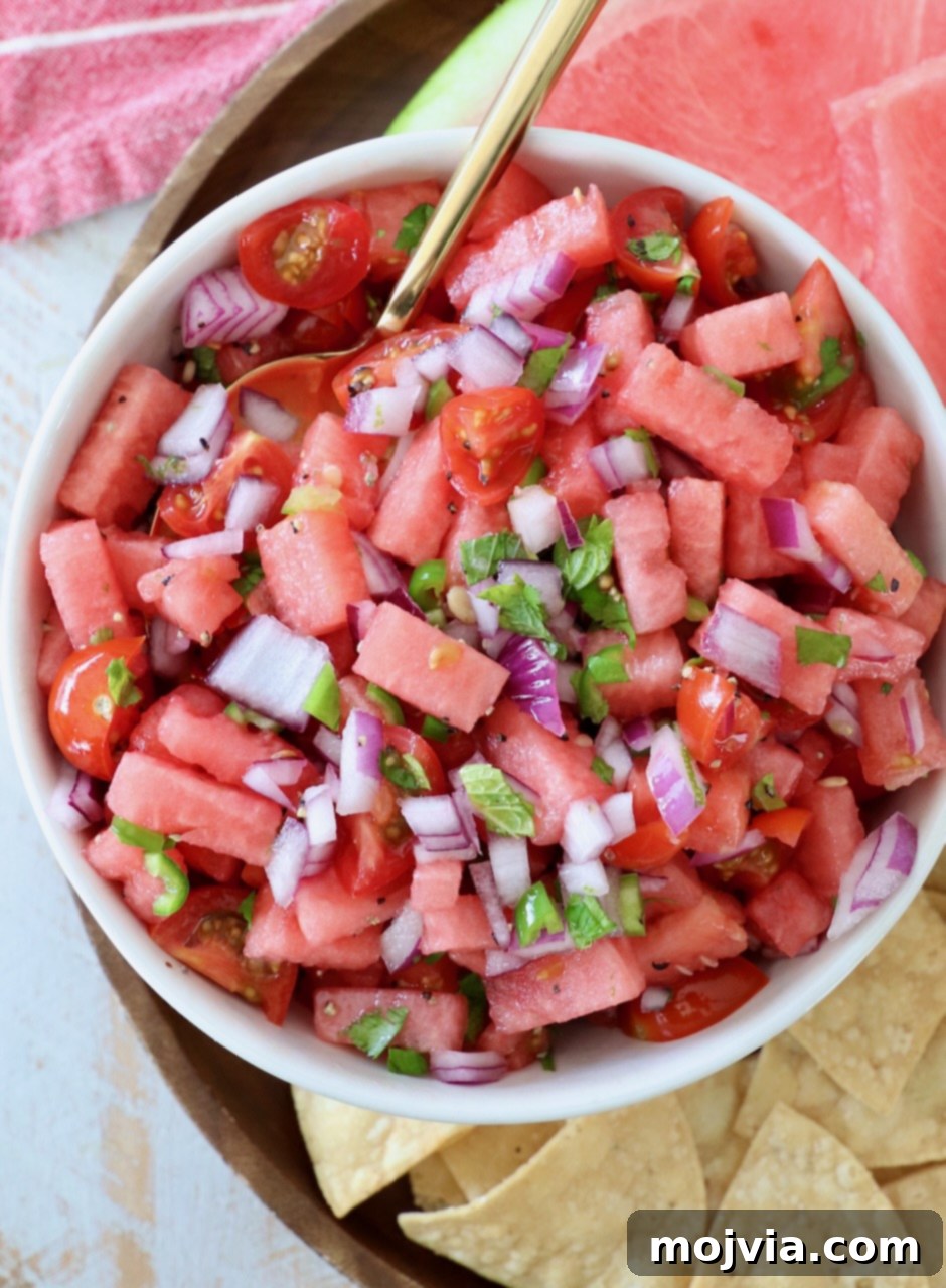 Sweet Heat Watermelon Salsa 5 A bowl of fresh watermelon salsa with a spoon, ready to be enjoyed