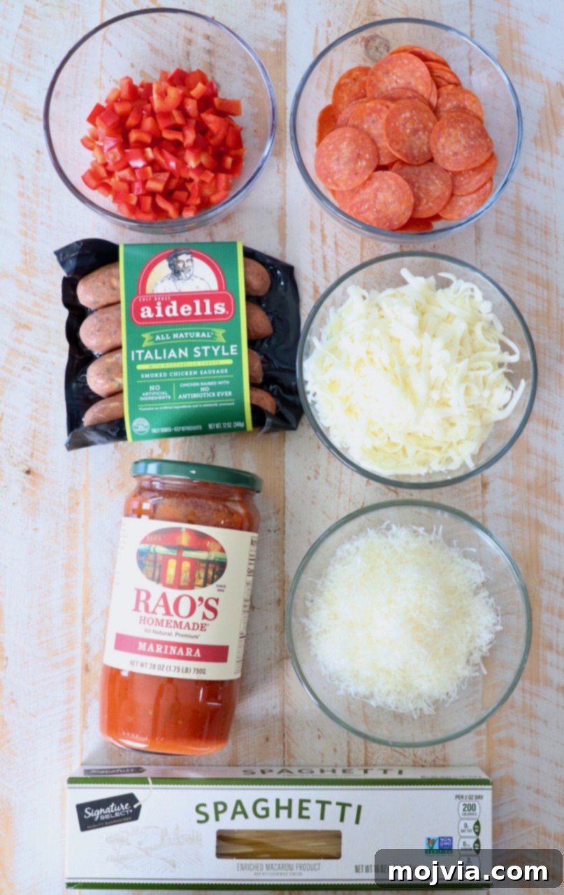 Ultimate Pizza Spaghetti Casserole 3 Various ingredients for pizza baked spaghetti laid out on a white wooden board, ready for preparation.