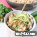 This One Pot Taco Rice Skillet recipe combines ground turkey, rice, veggies, spices & cheese for a quick and easy weeknight dinner that is so delicious!