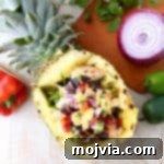 Grilled chicken teriyaki is served over zucchini noodles and topped with pineapple salsa in these healthy, gluten free and delicious zoodle bowls!