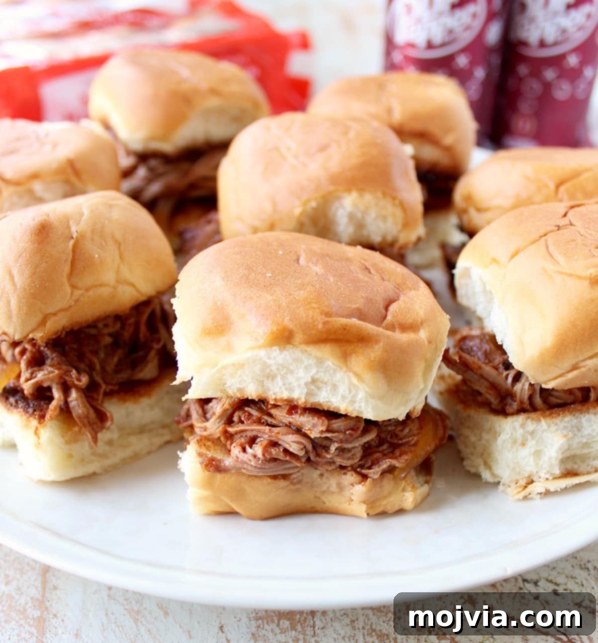 Sweet and Smoky Dr Pepper Pulled Pork Sliders 8 A plate of Dr Pepper pulled pork sandwiches on Hawaiian rolls, ready to be enjoyed.