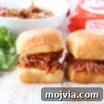 Luau Slow Cooker Chicken Sliders 2 Hawaiian Chicken Sliders made with slow-cooked chicken, pineapple, and Hawaiian BBQ sauce.