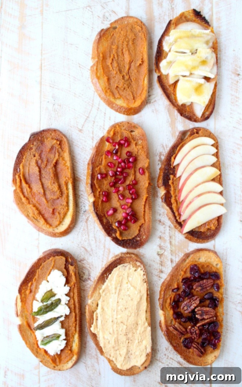 An inviting overhead view of a collection of seven pumpkin toast slices, each meticulously topped with diverse sweet and savory ingredients, arranged elegantly on a white wooden serving board, showcasing the recipe's versatility.