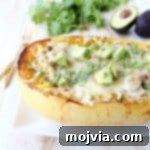 Green chili chicken is stuffed in roasted spaghetti squash and topped with gooey, melted pepper jack cheese for a delicious gluten free fall meal!