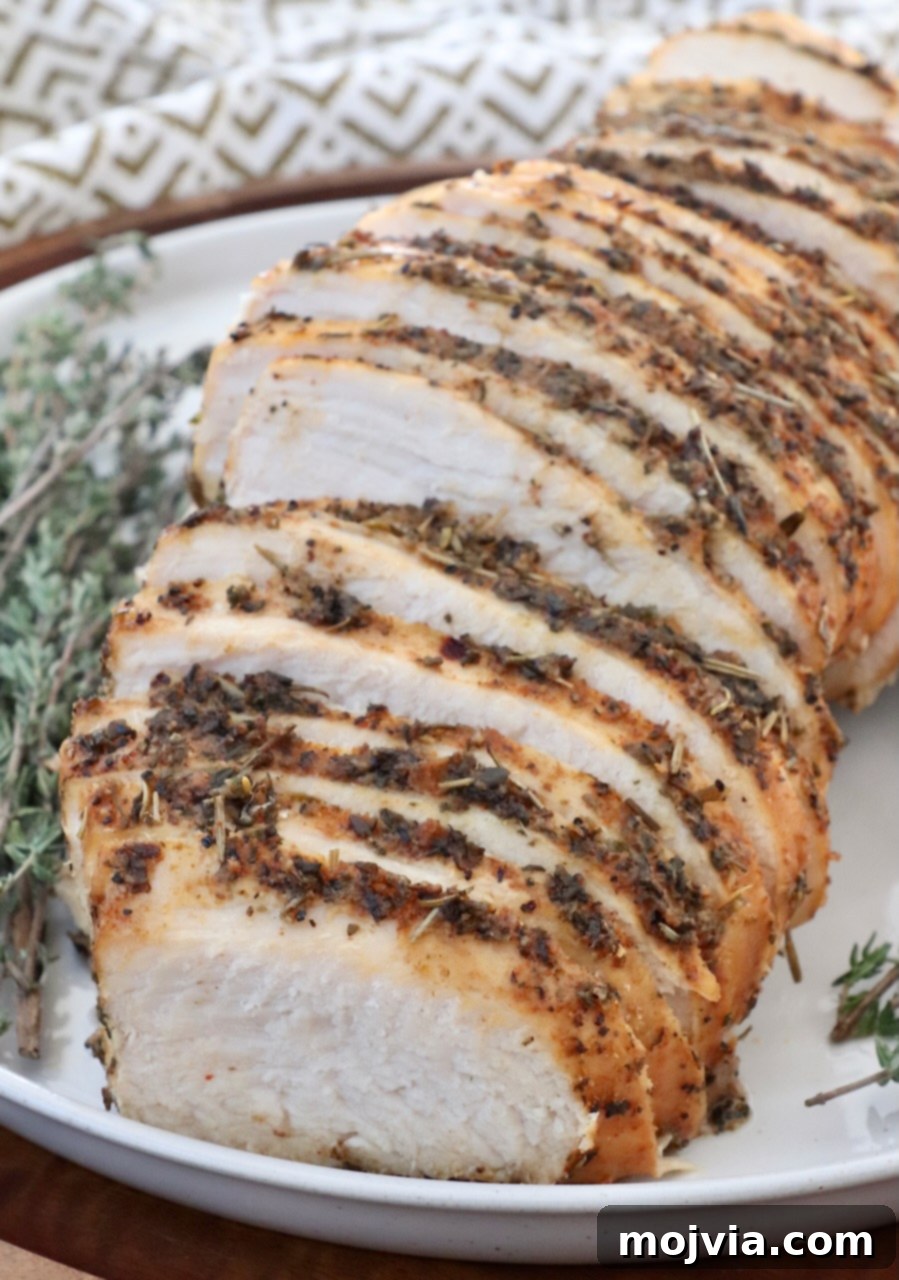 Melt-in-Your-Mouth Slow Cooker Turkey 11 A plate of perfectly sliced slow cooker turkey breast, ready to be served, showcasing its tender texture.
