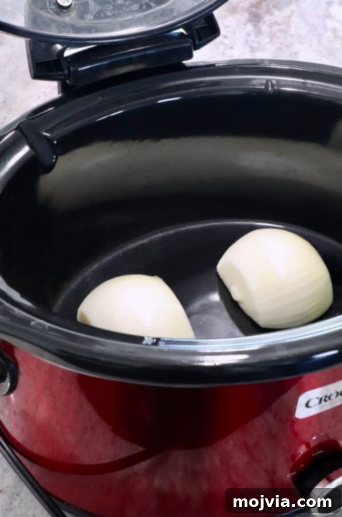 Melt-in-Your-Mouth Slow Cooker Turkey 6 Halved onion pieces placed cut-side down in the bottom of a slow cooker, creating a natural trivet.