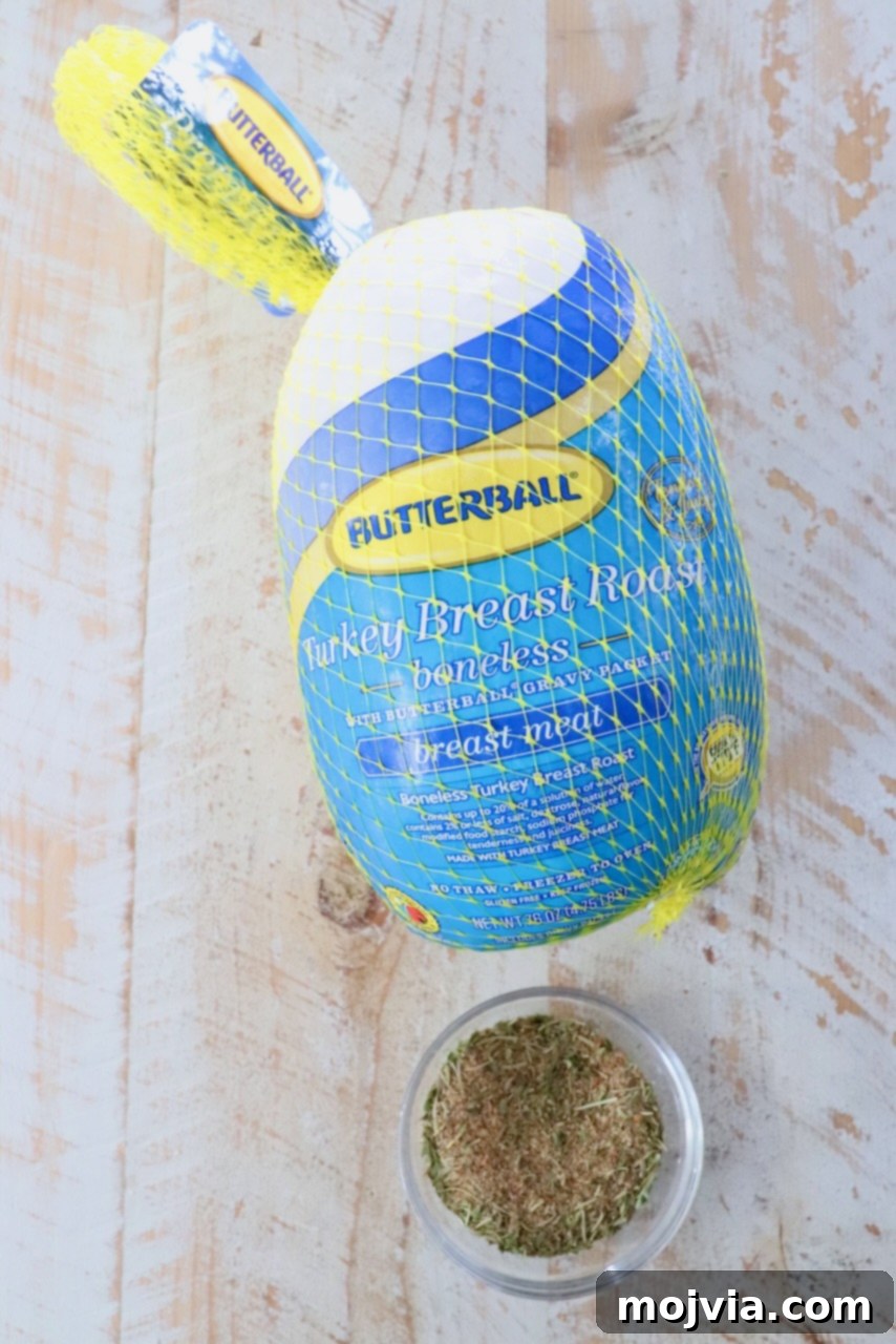 Boneless turkey breast in its original packaging next to a small bowl filled with savory turkey seasoning, ready for preparation.