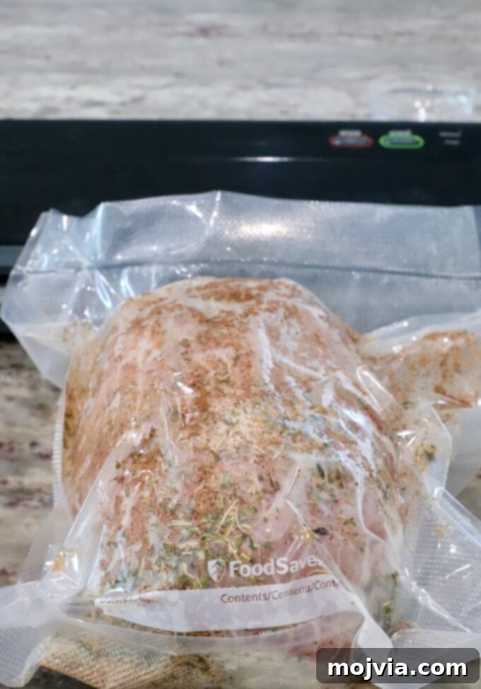 Boneless turkey breast perfectly vacuum-sealed in a bag with a generous rub of turkey seasonings, ready for the water bath.