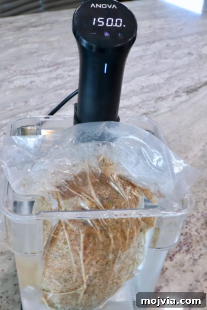 Vacuum-sealed turkey breast submerged in a temperature-controlled water bath, with a sous vide immersion circulator attached to the side of the pot, ensuring even cooking.