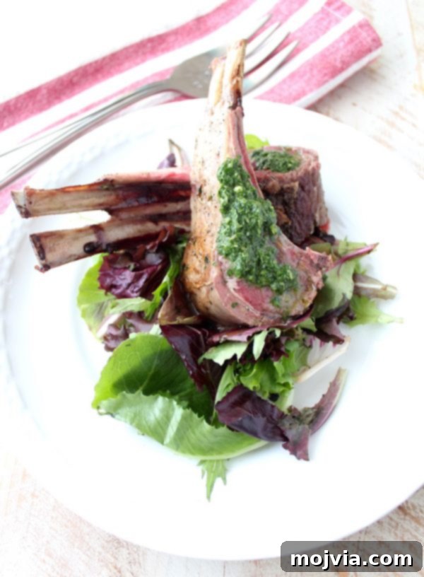 Succulent Herb Butter Roasted Lamb with Vibrant Mint Chimichurri 5 A full rack of lamb, before slicing, showing off the perfectly roasted exterior and herb crust.