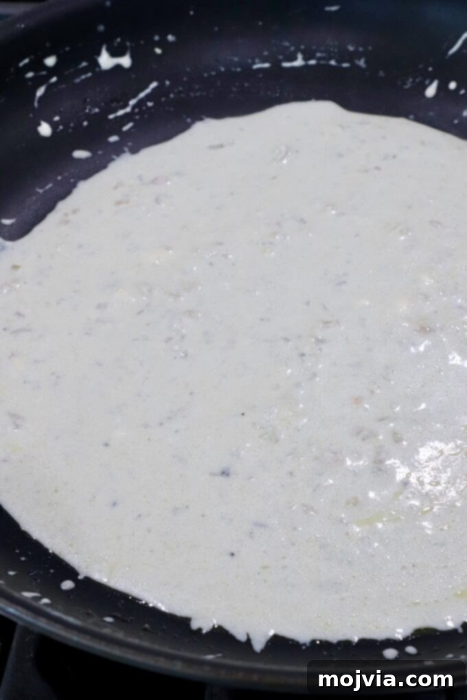 Close-up of creamy gorgonzola sauce in a skillet, ready to be served.