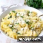 Baked spaghetti squash is tossed with a simple spinach artichoke sauce in this healthy, gluten free and vegetarian recipe, made in under an hour!