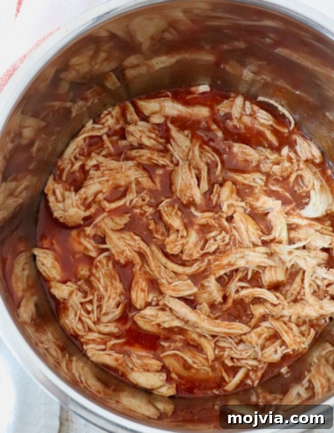 Spicy Shredded Instant Pot Buffalo Chicken 7 Cooked, shredded buffalo chicken remaining in an Instant Pot
