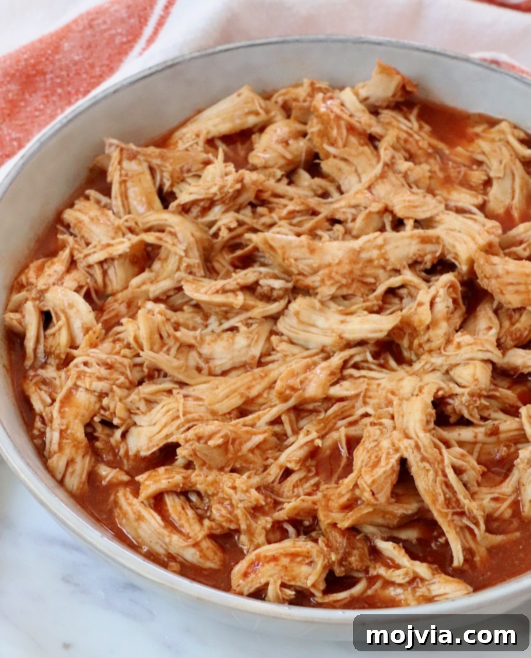 Spicy Shredded Instant Pot Buffalo Chicken 9 Shredded buffalo chicken in a bowl, ready to serve