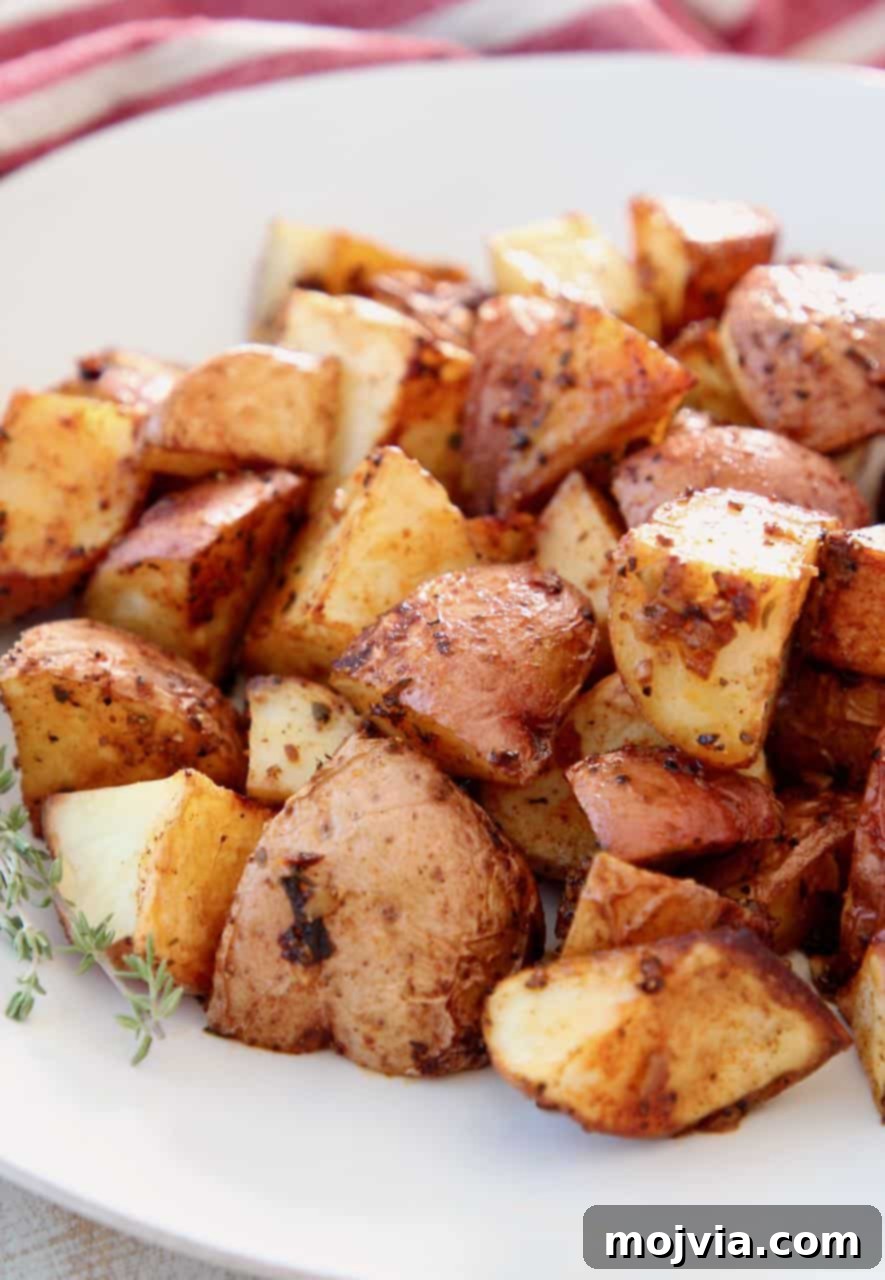 Roasted cubed potatoes on white plate