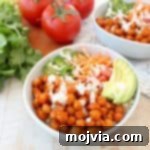 Buffalo chickpeas, quinoa and veggies are tossed together in this healthy, gluten free, vegan buddha bowl recipe, topped with an easy homemade vegan ranch dressing, all made in just 20 minutes!