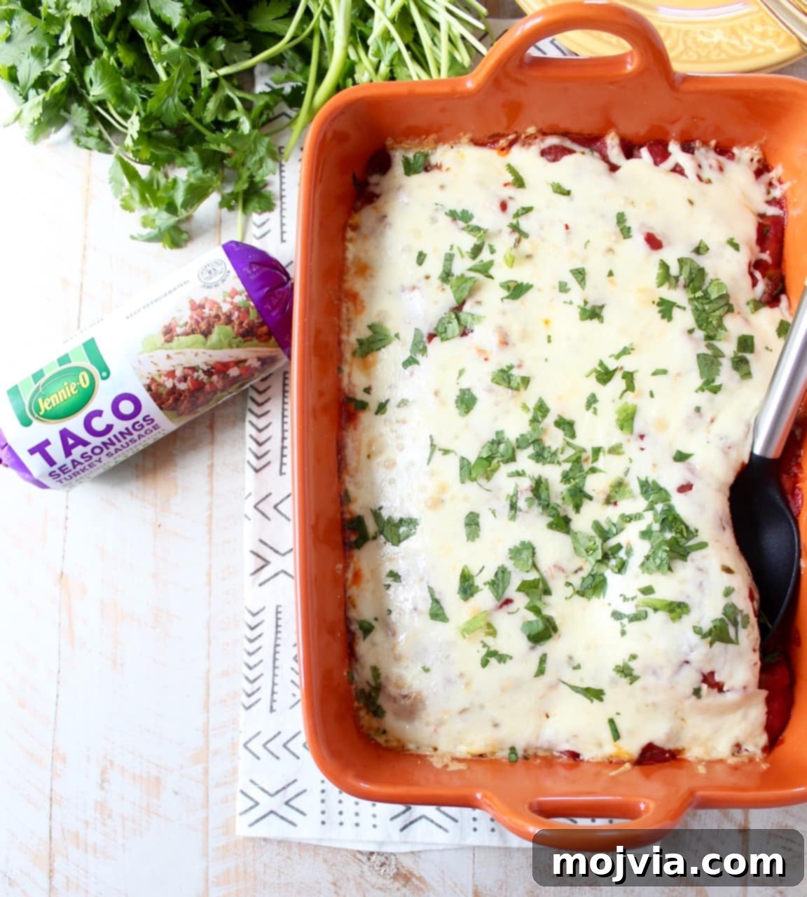 The finished gluten-free taco casserole, bubbling with cheese, hot out of the oven in a baking dish.