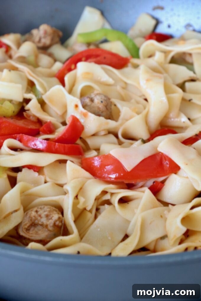 Boozy Italian Pasta 7 sliced bell peppers tossed with cooked noodles in large pan