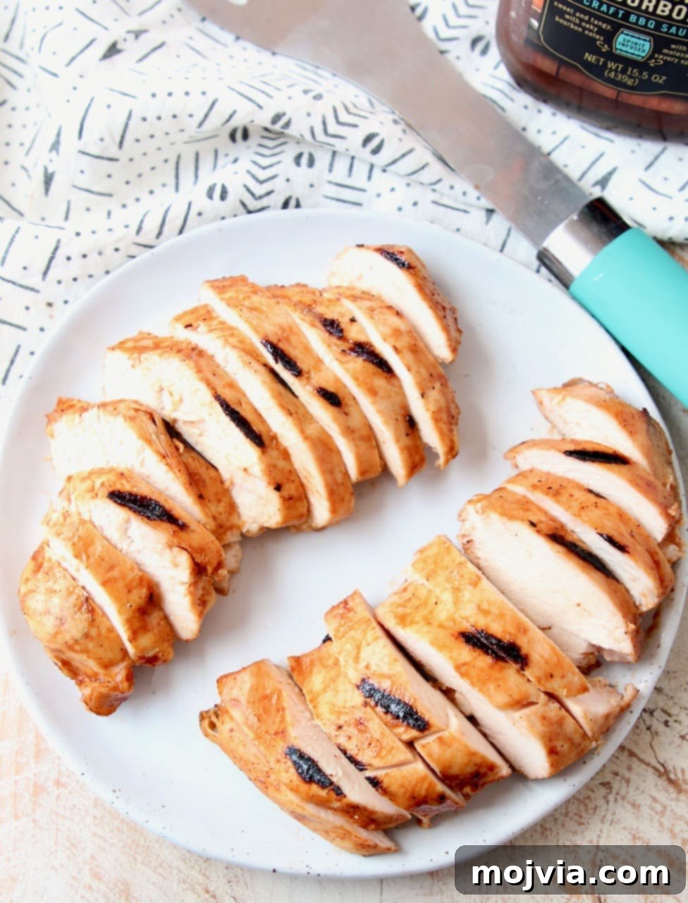 Perfectly Sliced Sous Vide BBQ Chicken Ready to Serve on a cutting board, garnished for presentation