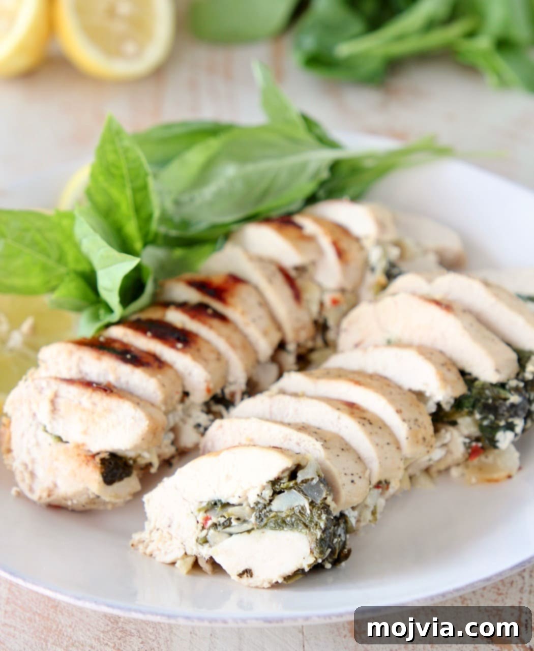 Tuscan Spinach Artichoke Chicken 2 Sliced Spinach Artichoke Chicken with Fresh Basil and Lemons