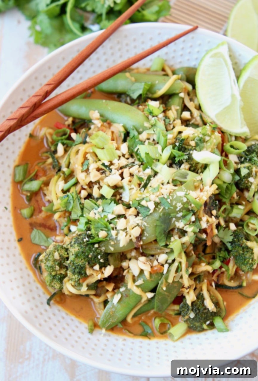 Zucchini Noodle Pad Thai: A Fresh Vegan Spin 2 A beautifully plated bowl of Vegan Pad Thai with Zucchini Noodles, garnished with sugar snap peas, crushed peanuts, and fresh scallions.
