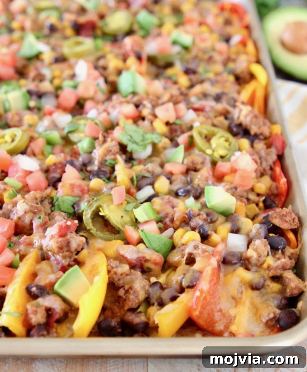 Low Carb Nachos made with sweet mini peppers topped with taco seasoned turkey, beans, tomatoes, corn, jalapenos and cheese
