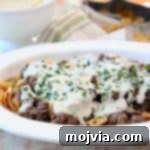 Frito Cheesesteak Pie with ground beef and creamy provolone sauce in casserole dish