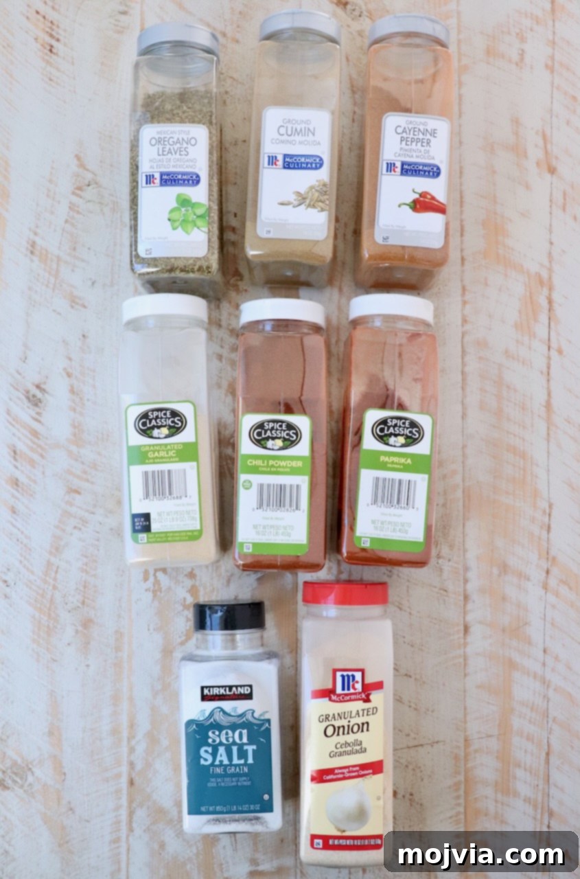 taco seasoning ingredients laid out on a white wood board, ready for mixing