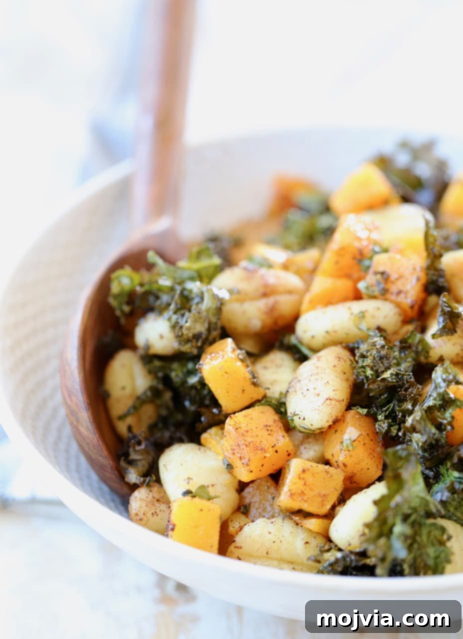 Delicious Sheet Pan Gnocchi with roasted butternut squash and crispy kale in a rustic bowl, ready to serve.
