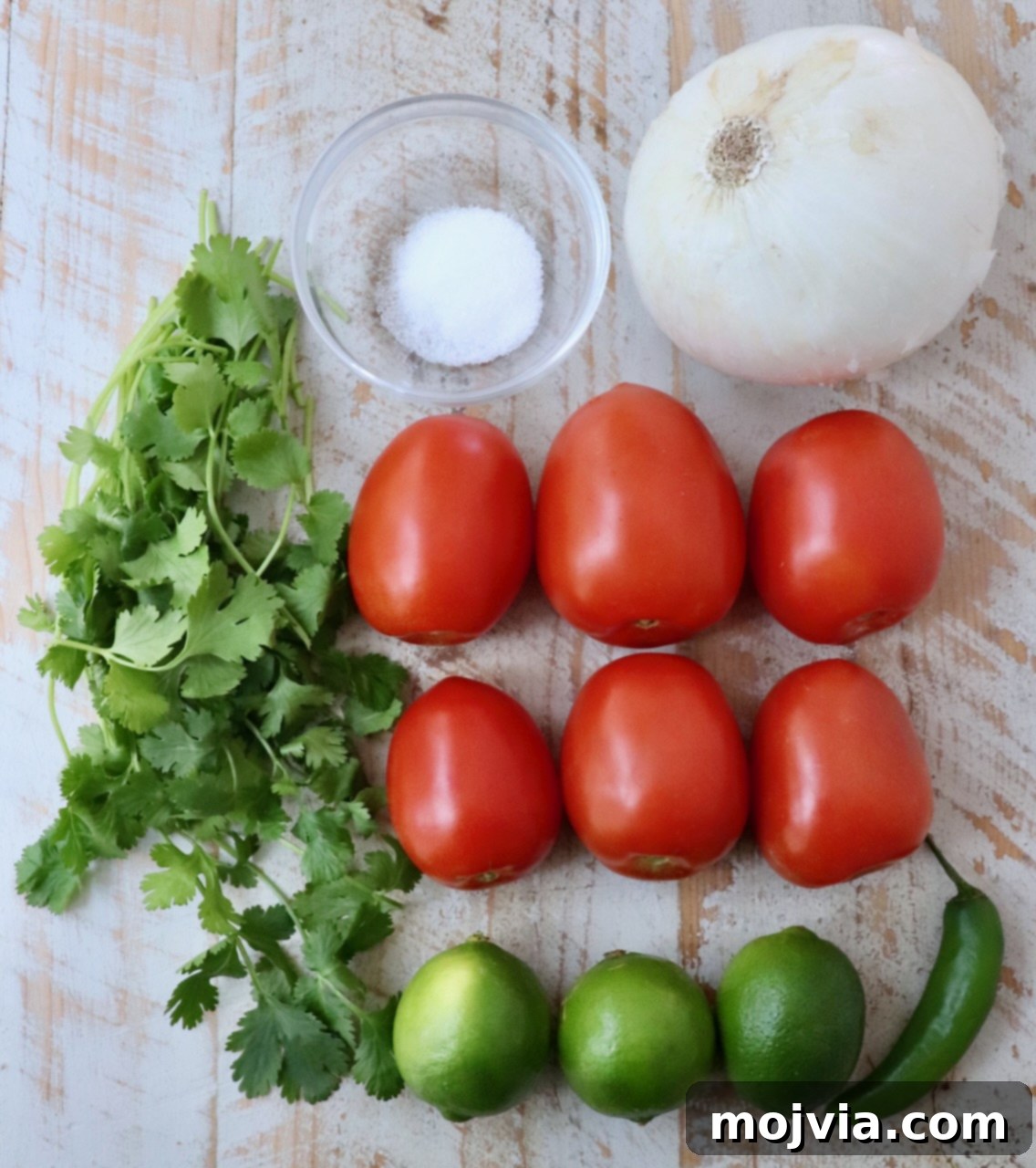 Fiesta Fresh Salsa 3 ingredients for pico de gallo on a white wood board