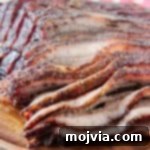 Perfectly sliced smoked brisket on a rustic wooden tray, ready to serve.