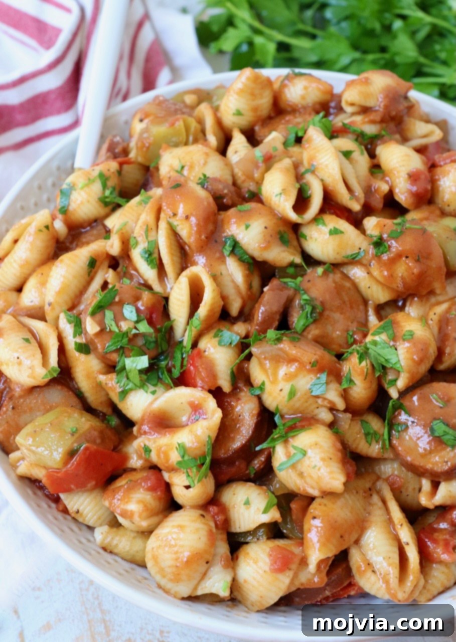 Spicy Cajun One-Pan Pasta 2 Cajun pasta with sausage and peppers in a large bowl with a fork, ready to be served.