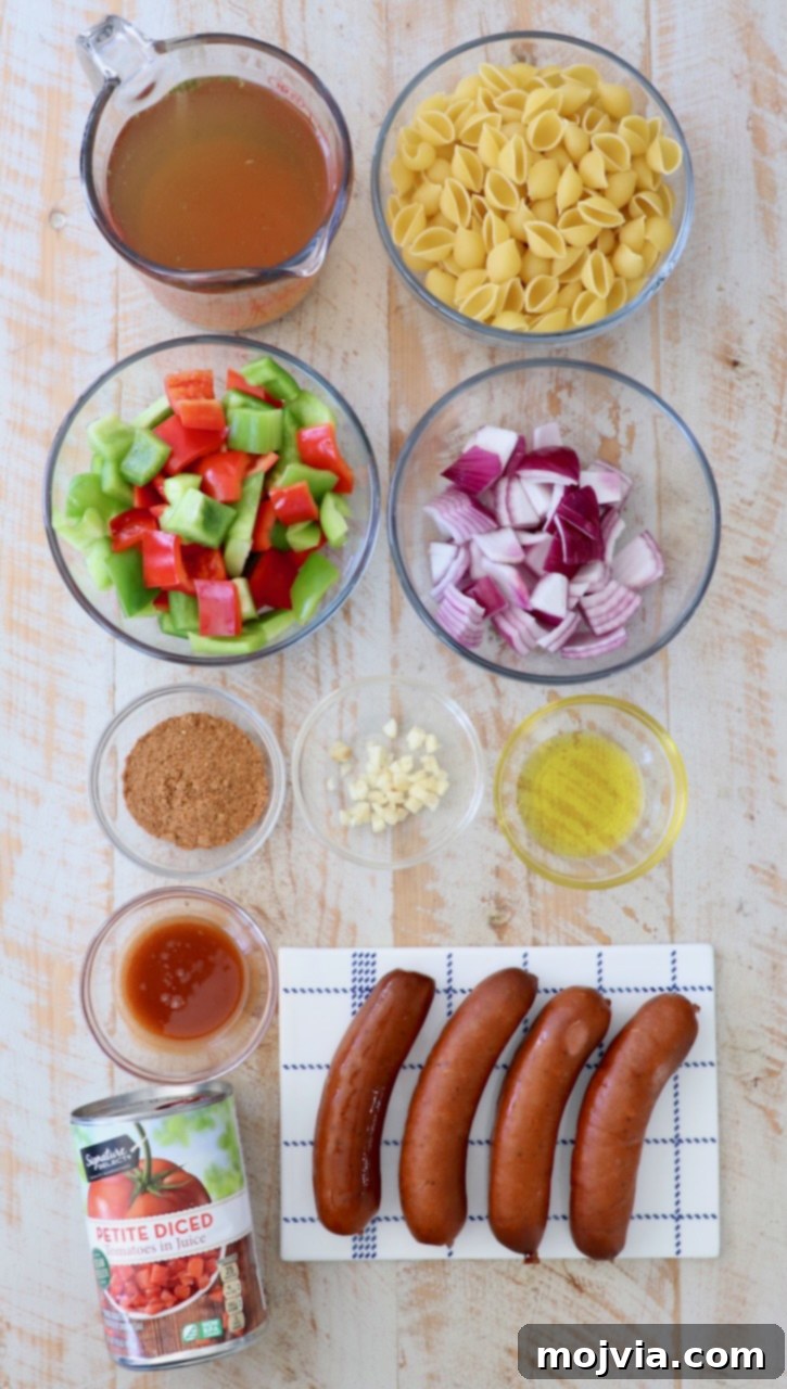 Spicy Cajun One-Pan Pasta 3 Cajun pasta ingredients neatly laid out on a white wood board, ready for preparation.