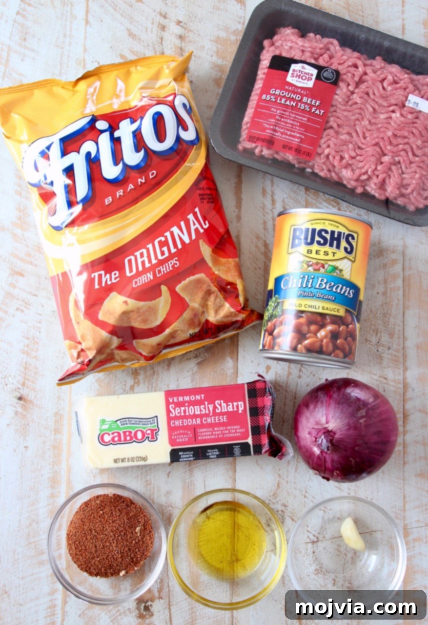 Tex-Mex Chili Crunch 3 A vibrant collage of ingredients for Frito Chili Pie, neatly arranged on a countertop