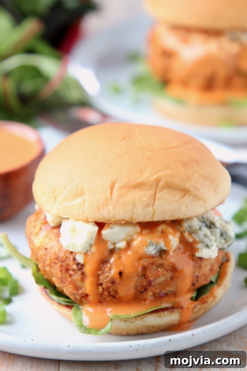 Fiery Buffalo Chicken Burgers 6 Buffalo chicken burger on a bun with blue cheese crumbles