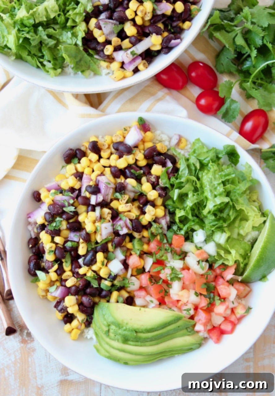 Plant-Powered Burrito Bliss 2 Burrito bowl filled with corn and black bean relish, pico de gallo, avocado and shredded lettuce