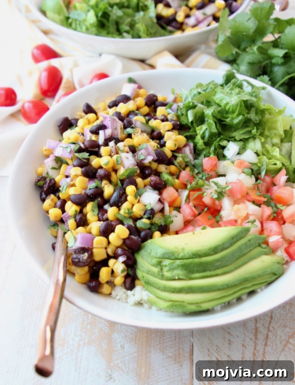 Plant-Powered Burrito Bliss 3 Vegan burrito bowl topped with avocado, black beans, corn, tomatoes and romaine lettuce