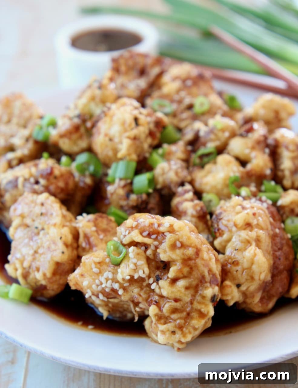 Gochujang Glazed Cauliflower Wings 5 Fried Cauliflower in Korean BBQ Sauce on plate topped with diced green onions
