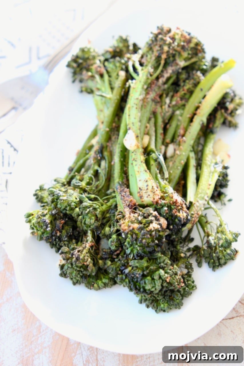 Golden Roasted Garlic Parmesan Broccolini 3 Perfectly roasted broccolini adorned with grated Parmesan cheese, ready to be served as a healthy side dish.