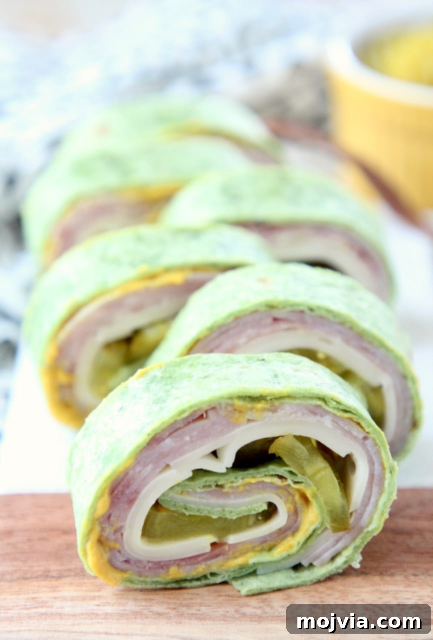 Side view of Cuban pinwheels on a wooden board, showcasing their layered filling