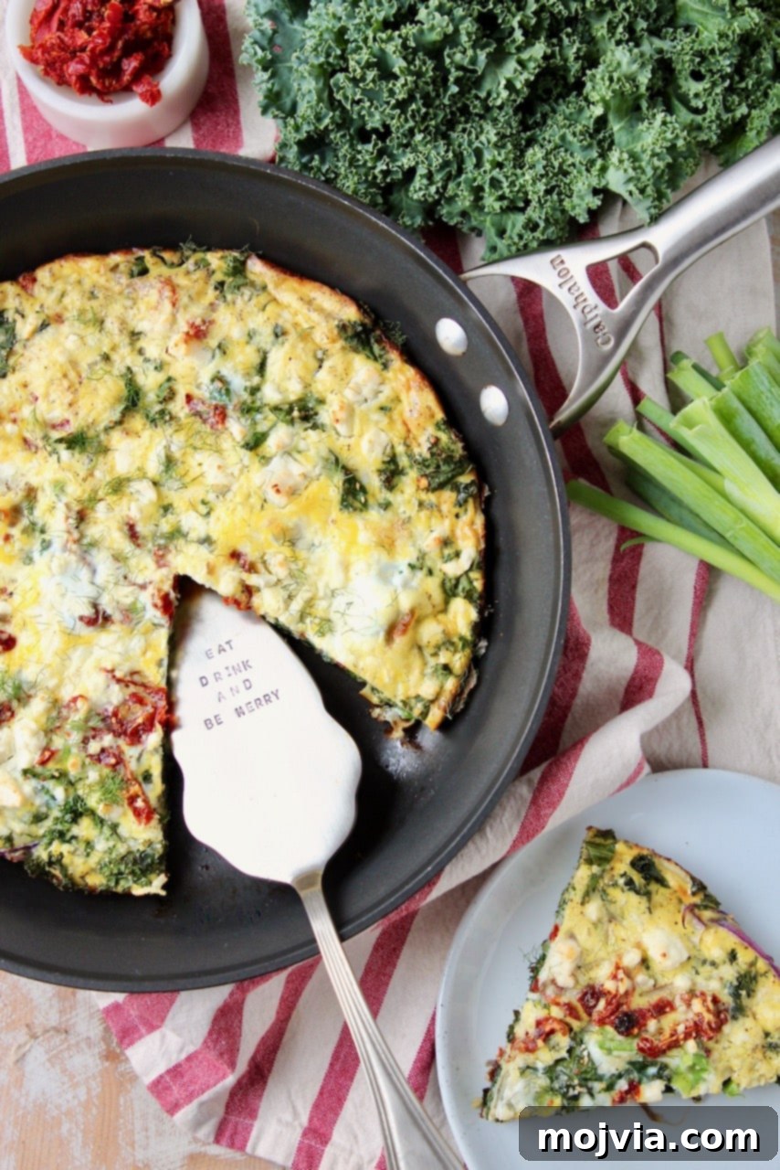 Sun-Kissed Mediterranean Frittata 3 Frittata in a cast iron skillet, with a perfect slice cut out and placed on a plate to the side, ready to be enjoyed.