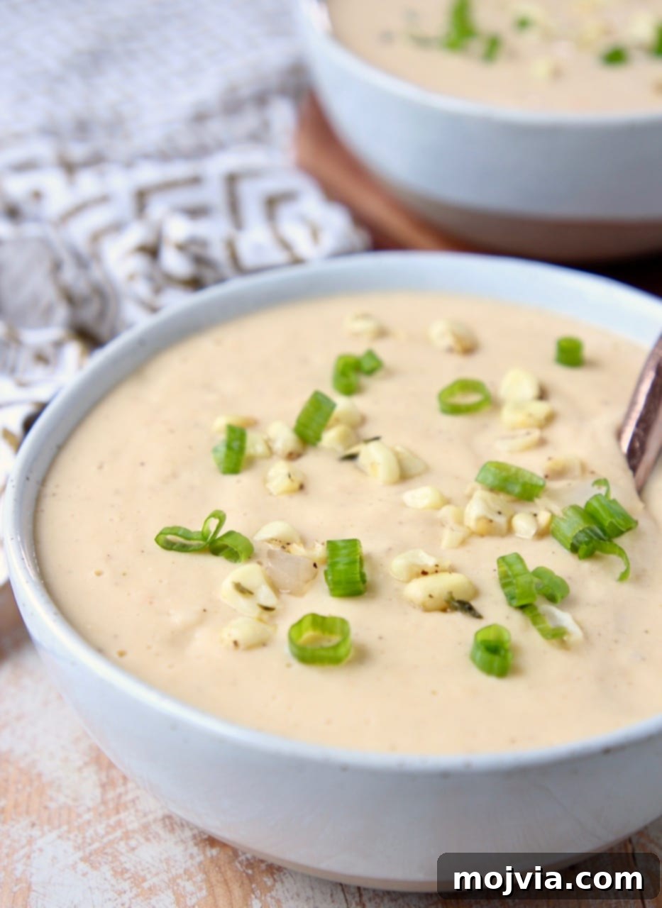 Golden Creamed Corn Soup 4 Creamy sweet corn chowder in bowl with copper spoon