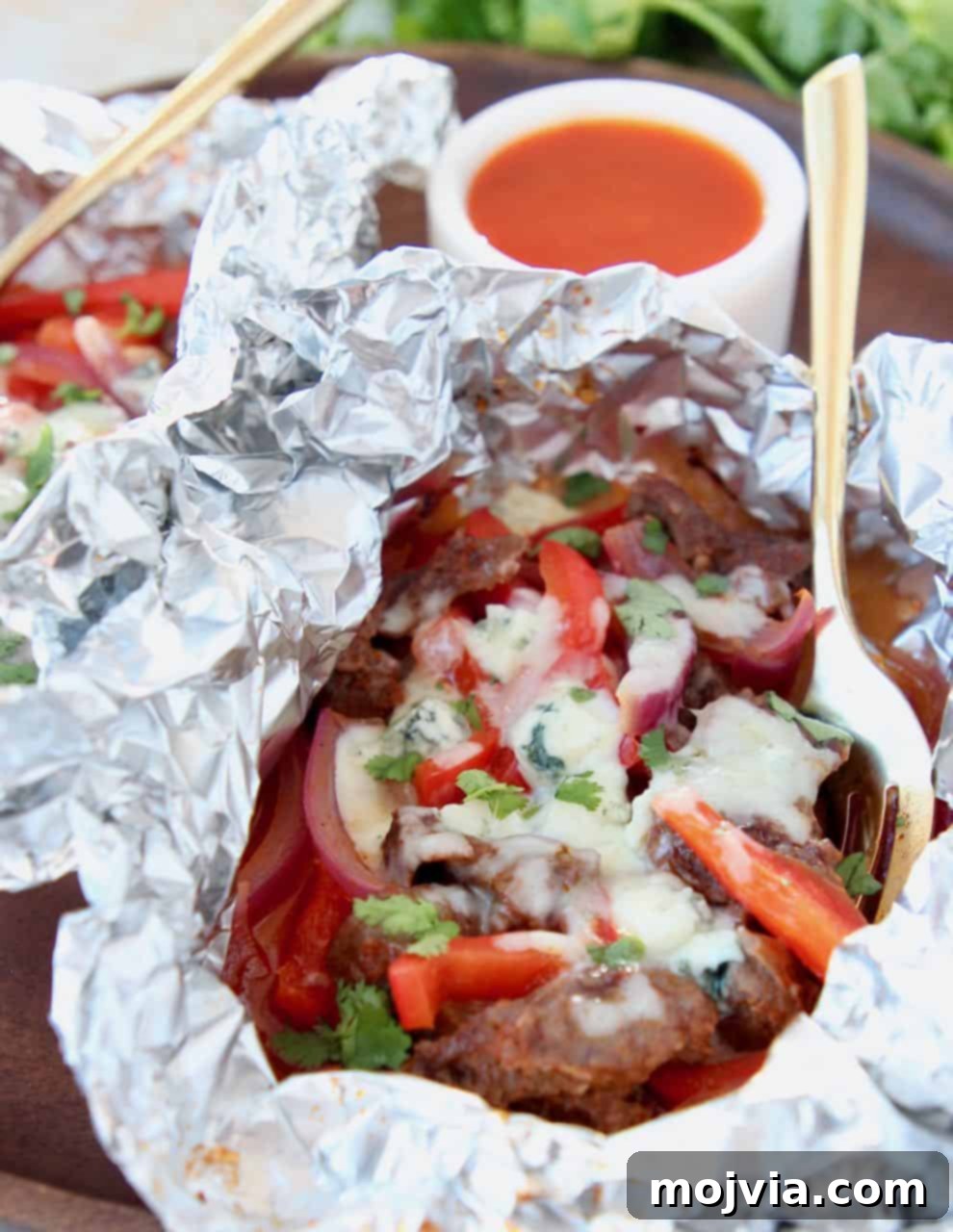 Buffalo cheesesteak meat and peppers in foil pack