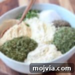 Ultimate Homemade Ranch Spice Blend 6 Ranch seasoning ingredients in a bowl with a spoon