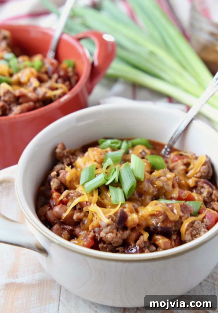 Hearty Gluten-Free Chili 2 Chili in small crock bowls with silver spoon in the bowl