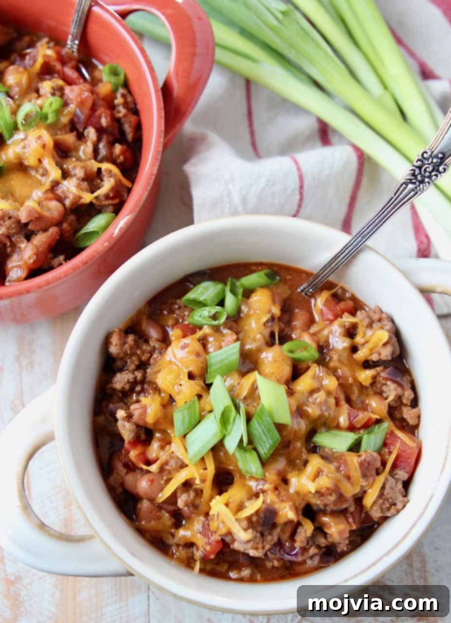 Hearty Gluten-Free Chili 3 Overhead image of chili in crocks with silver spoon and green onions