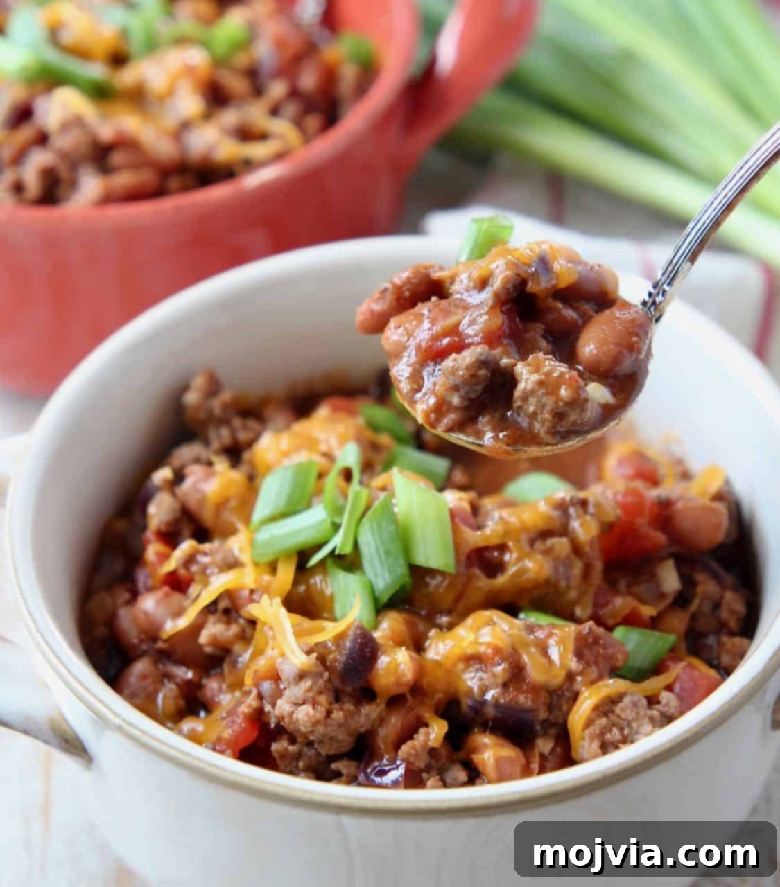 Hearty Gluten-Free Chili 4 Chili in white bowl with spoonful of chili coming out of the bowl