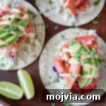 Overhead image of lobster tacos topped with remoulade sauce, showcasing the delicious drizzle.
